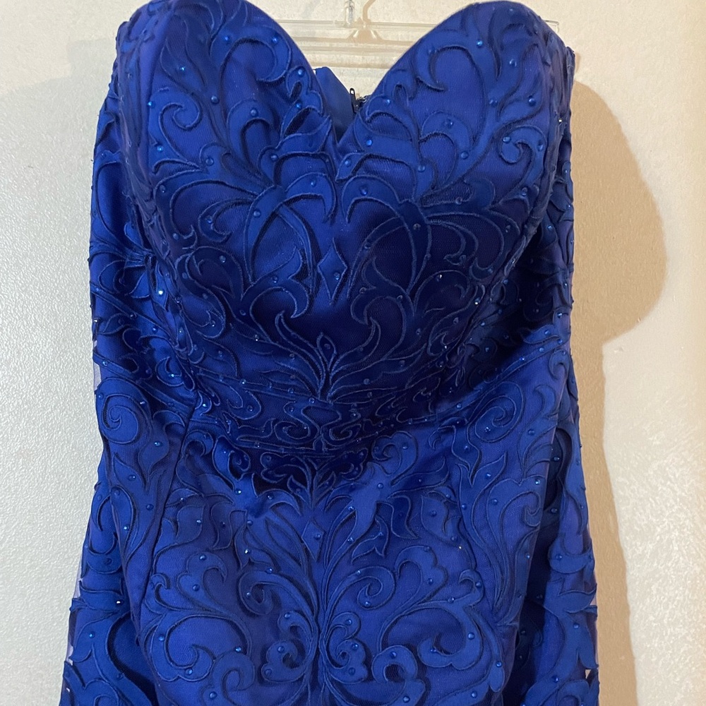 La Perle cobalt blue beaded lace mermaid dress with matching sheer lace jacket.